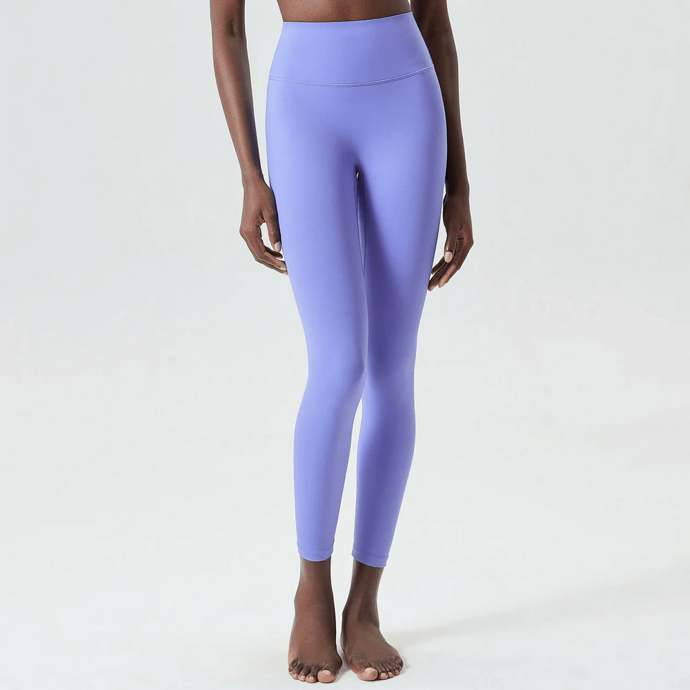 Woman wearing stylish purple ankle-length yoga leggings, perfect for versatile workouts and active lifestyles.